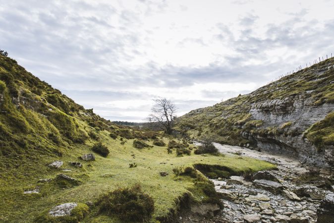 Valley between hills and cloudy sky