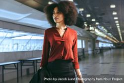 Black woman standing at airport terminal 5qYxa5