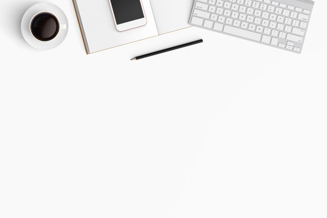 Modern workspace with coffee cup, smartphone, paper, notebook, tablet and laptop copy space
