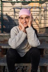 Positive woman in symbolic pink scarf on stairway