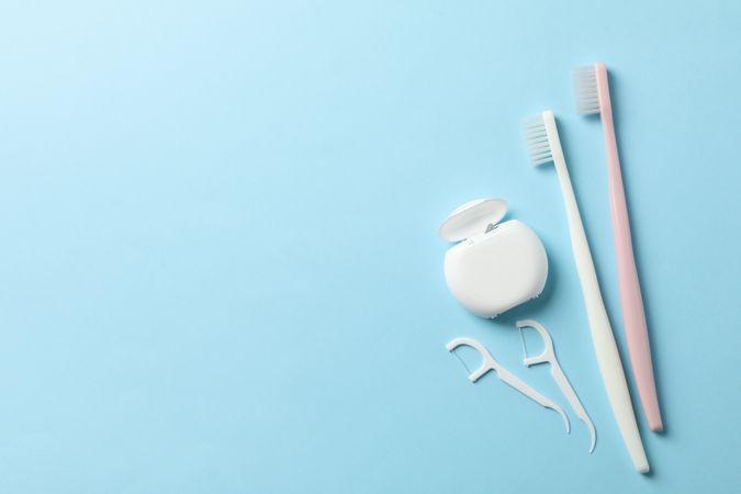 Tools for dental care on blue background, space for text