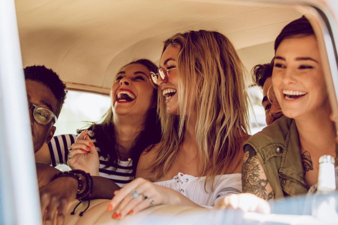 Cheerful young people enjoying a road trip