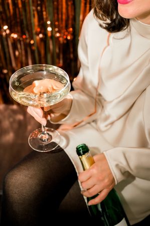 crop of woman holding champagne flute