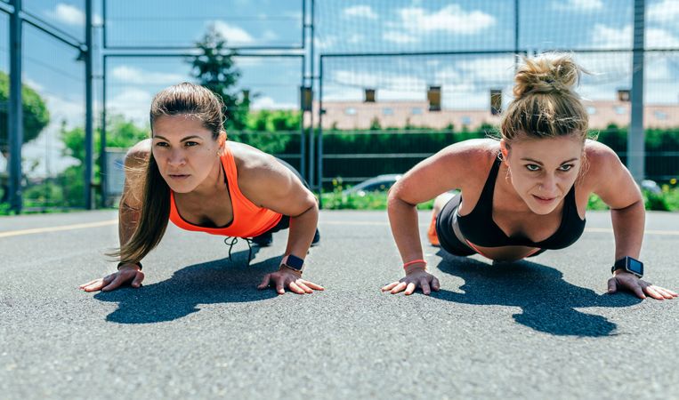 Sportswomen doing push-ups