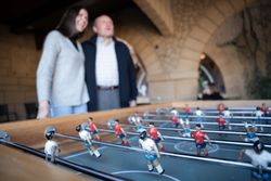 Some table football figures with a grandfather and his granddaughter in the background