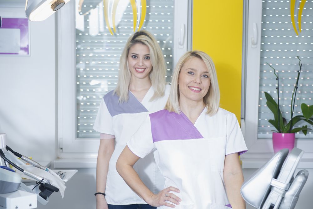 Two blonde dental professionals they bright office