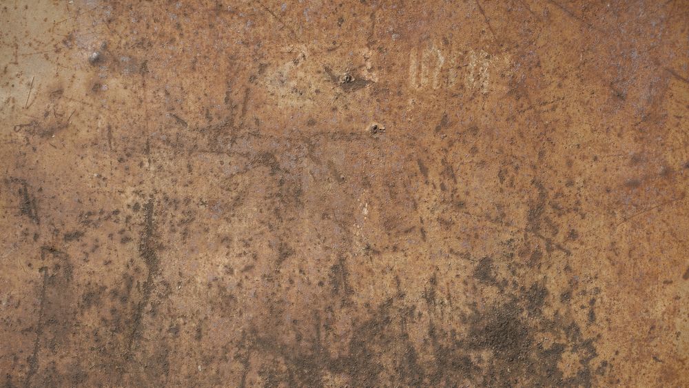 Rusty brown steel wall with dark patches and weathered grunge texture