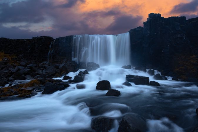 Shutter speed photography of waterfall under cloudy sky