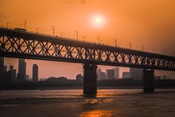 Bridge over river during sunset