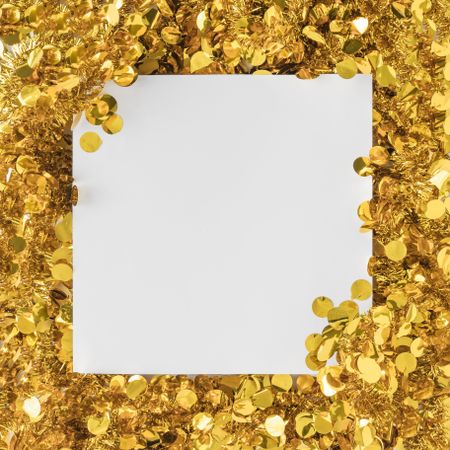 Golden confetti bordering paper card