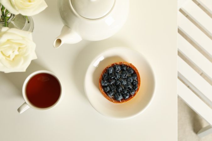 Concept of breakfast with blueberry pie on table