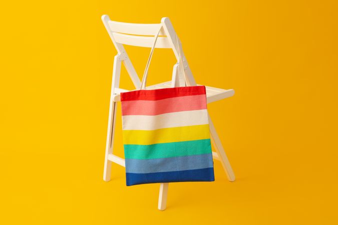 Concept of Pride parade, rainbow shopper, on color background.