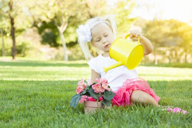 Cute Little Girl Playing Gardener with Her Tools and Flower Pot.