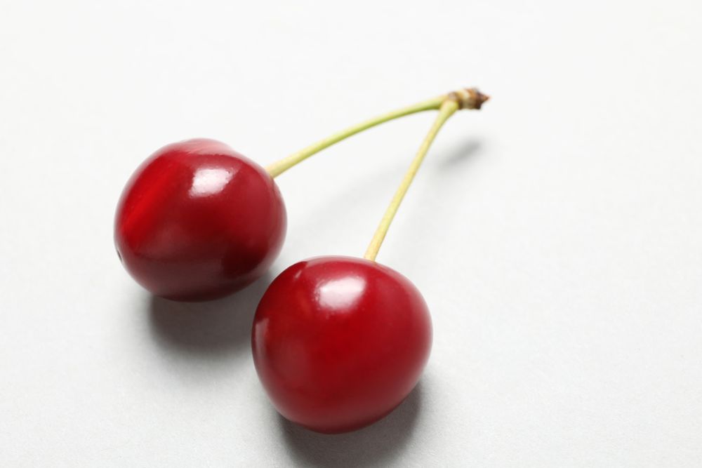 Ripe juicy cherry fruits on a light background