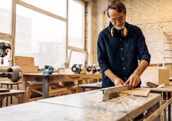 Woodworking working with electric saw in shop