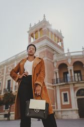 Stylish Black woman with handbag on street
