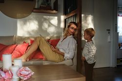 Mother relaxing on couch and looking at son