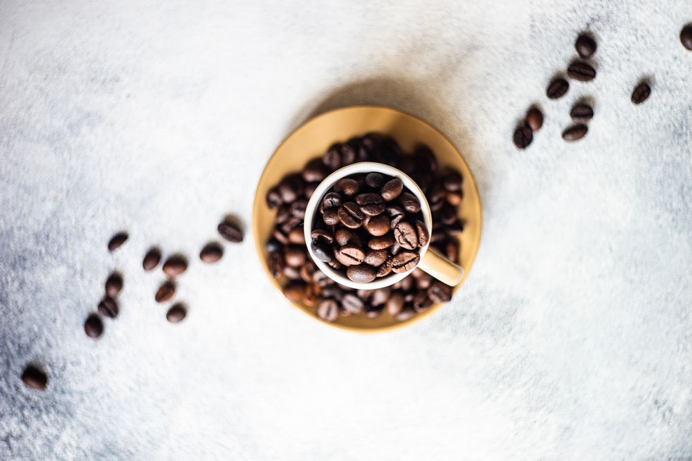 Top view of espresso cup full of coffee beans
