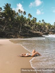 Woman in blue bikini lying on beach during daytime 56yRj0