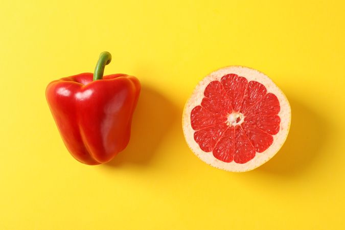 Cabbage and pepper on yellow background, space for text