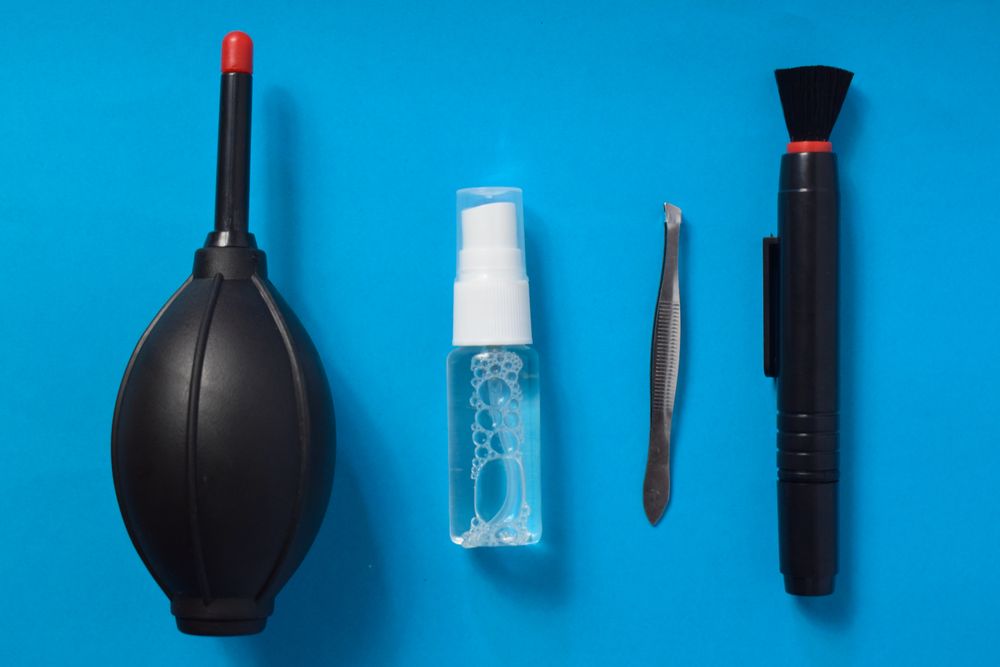 Top view of lens cleaning kit on blue background