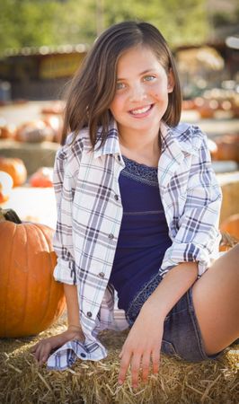 Smiling Preteen Girl Portrait at the Pumpkin Patch