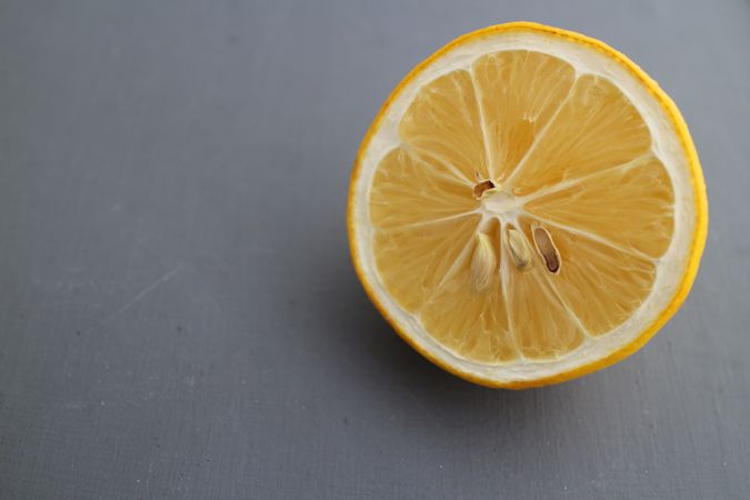 Sliced lemon in dark background, with copy space