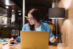 Focused female freelancer working in restaurant