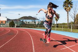 Slim woman running on stadium