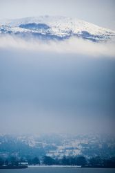 Amazing scenery of snowy mountain peak among lush clouds