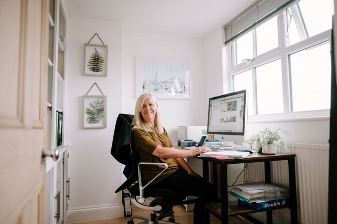 Older woman with grey hair working from home