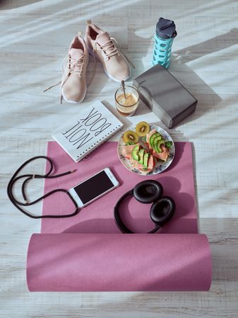 Healthy breakfast of athlete and coffee on yoga mat