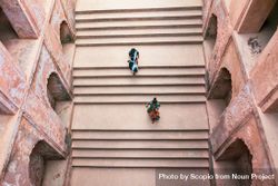 Top view of two girls walking on stepwell in Bara Imambrara, Lucknow, Uttar Pradesh, India 4MkOk0
