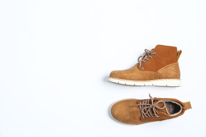 Winter boots on blank background, top view
