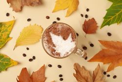 Composition with glass cup of latte on beige background