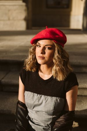 Stylish female in beret looking at camera