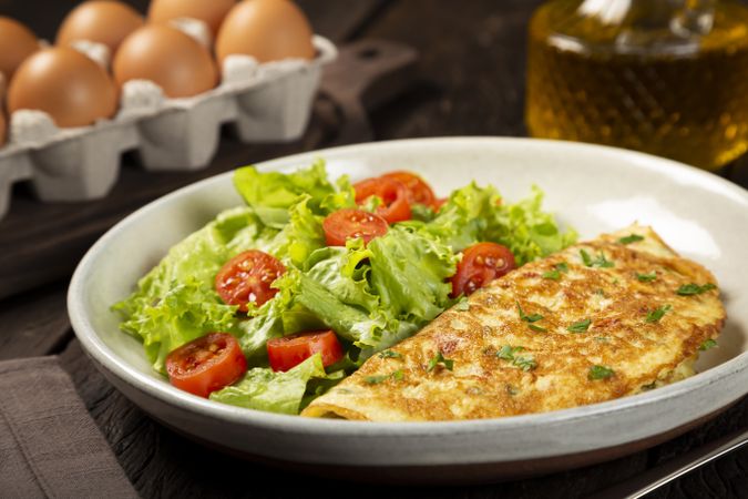 Omelet with cheese and lettuce and tomato salad.