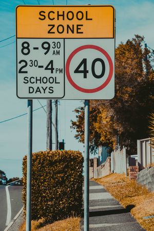 Speed Limit School Zone Sign On A Clear Day Near A Quiet Neighborhood