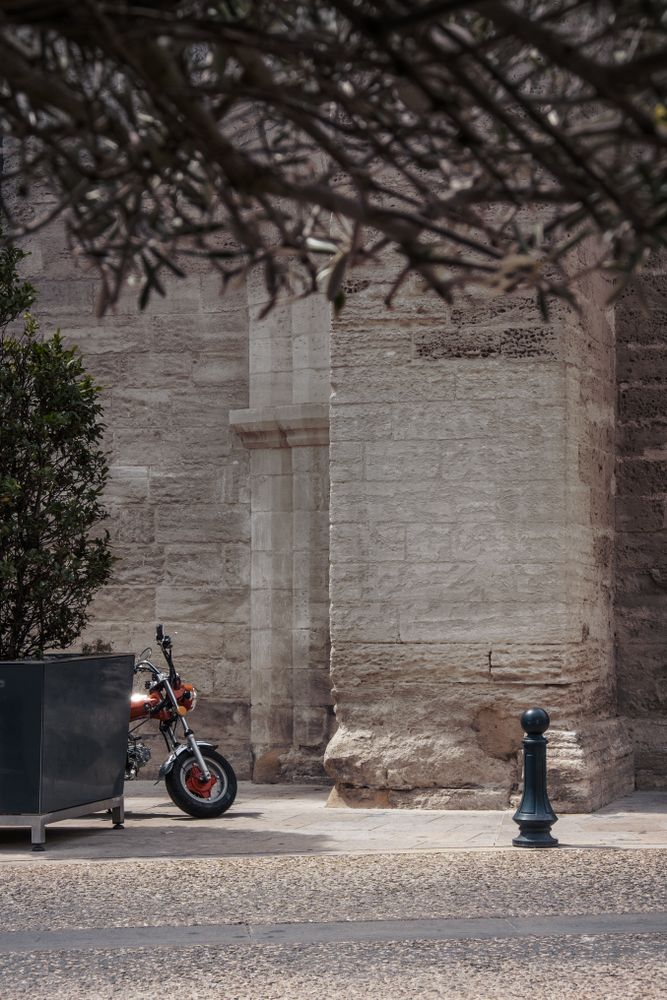 Motor cycle parked near stone building
