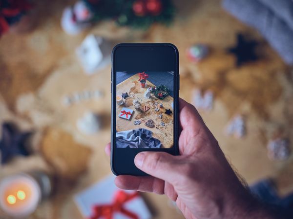 Unrecognizable traveler taking photo of souvenirs on map