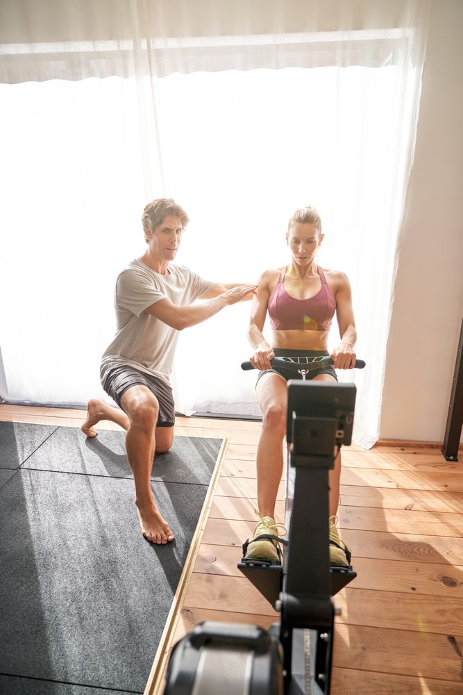 Woman doing exercises with personal trainer