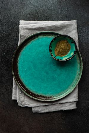 Teal plate with bowl of spice