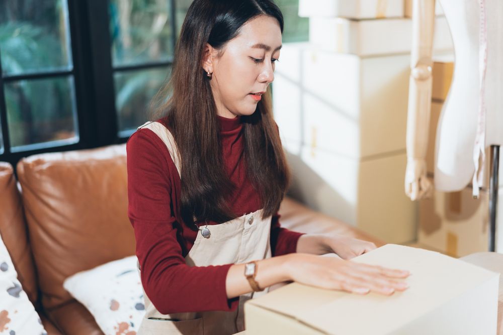 Woman packing a box at home