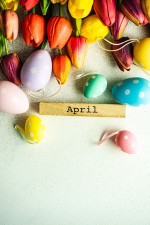 Flat lay of tulip flowers and dotted pastel eggs with space for text