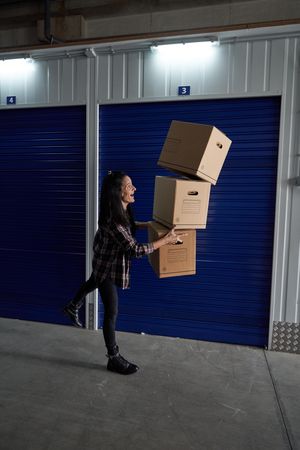 Woman with falling carton boxes