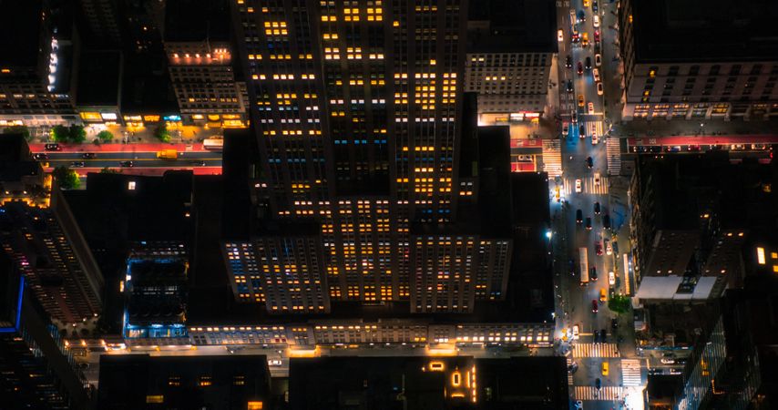 Aerial Photo of New York City and Manhattan Panoramic Skyline with Landmark Skyscraper Buildings at Night. Helicopter View of the Cityscape from Above with Towering Tourist Attractions