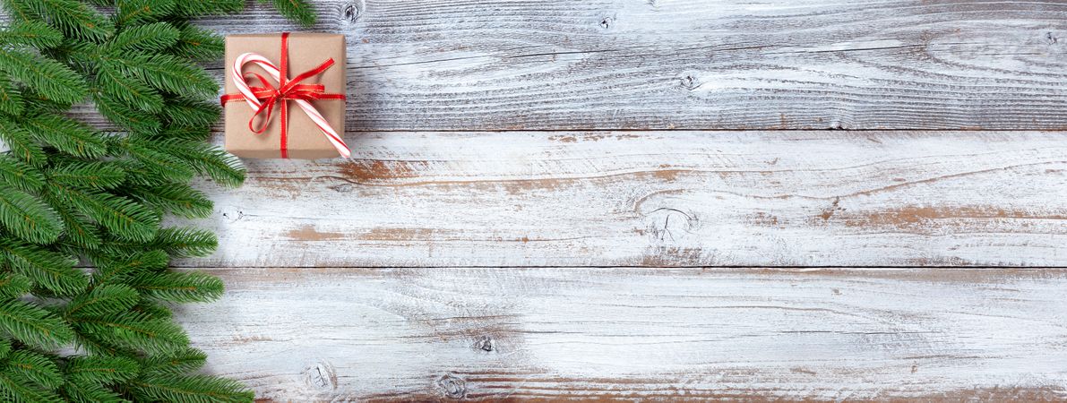 Christmas holiday evergreen branches on rustic wooden background