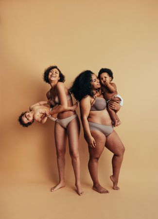 Playful women playing with their young children