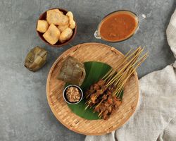 Top view of beef sate skewers served with spicy peanut sauce