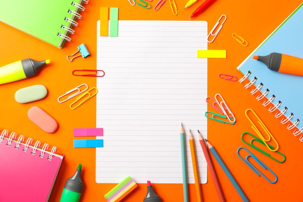 Flat lay composition with school supplies on color background, space for text
